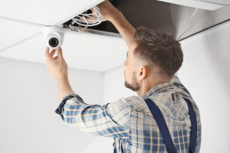 A man installing a new CCTV