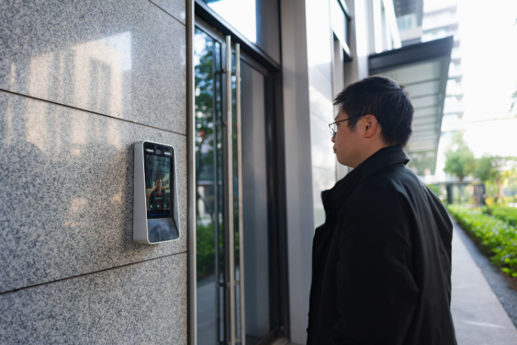 A man using facial recognition to gain home access