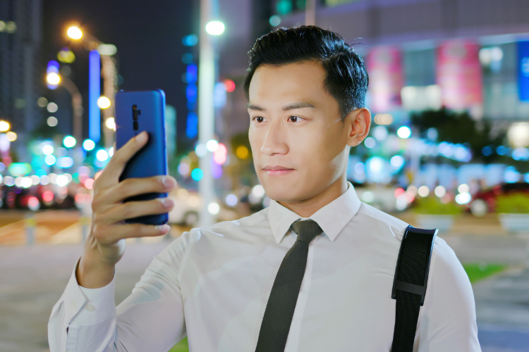 A man using smartphone facial recognition
