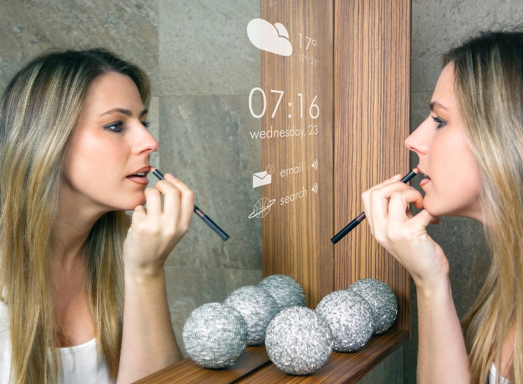 A woman using a smart mirror to put on makeup